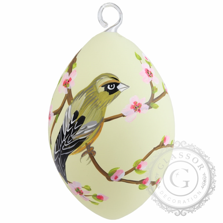 Bird on yellow Easter egg with flowers and leaves