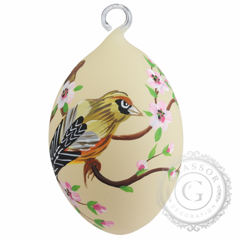 Bird on dark yellow Easter egg with flowers and leaves