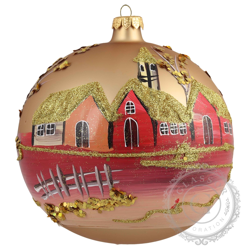 Glass bauble with golden red village motif