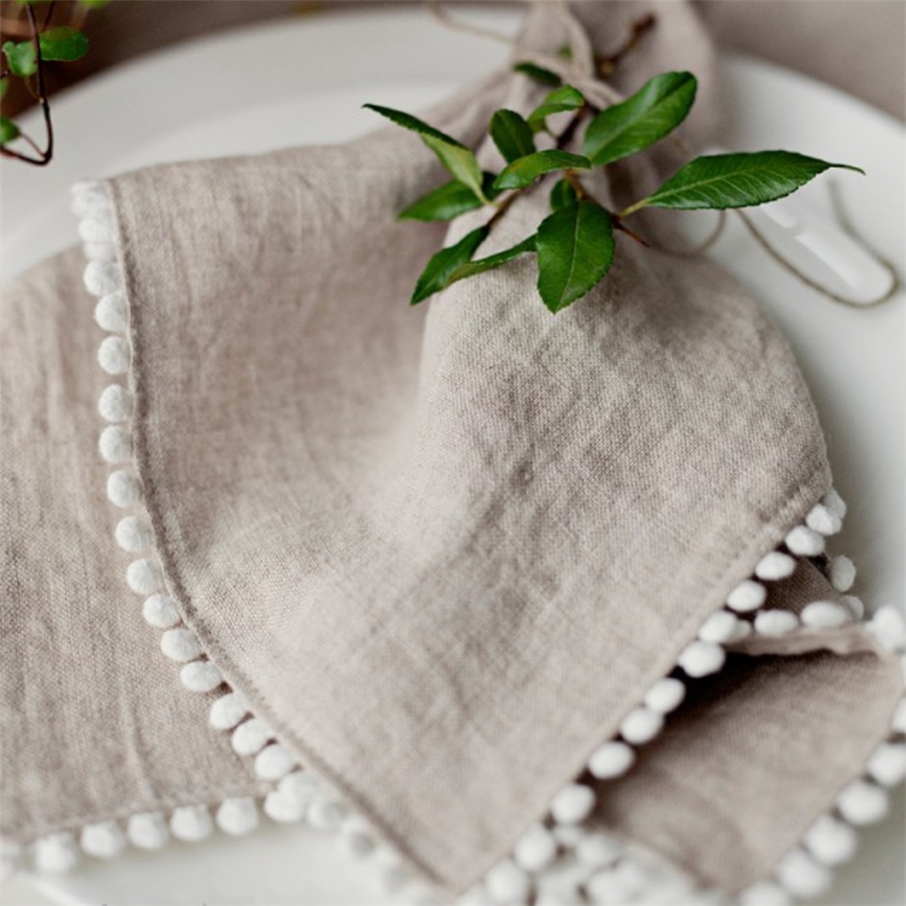 Set of linen napkins with pompoms