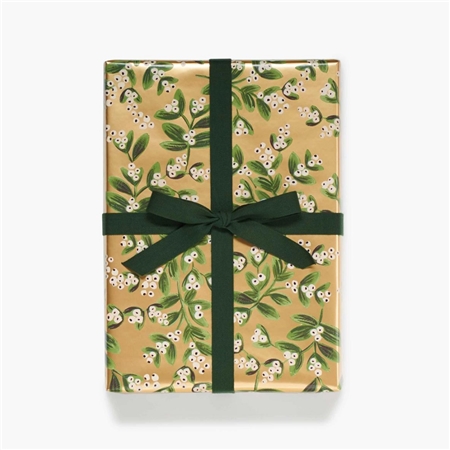 Golden gift wrapping paper with mistletoe twigs