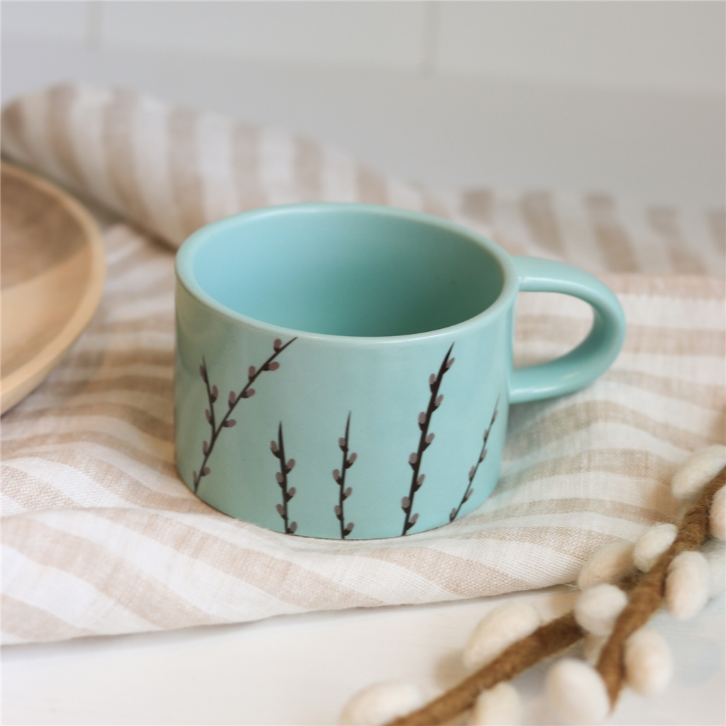 Pastel green mug with cat decoration