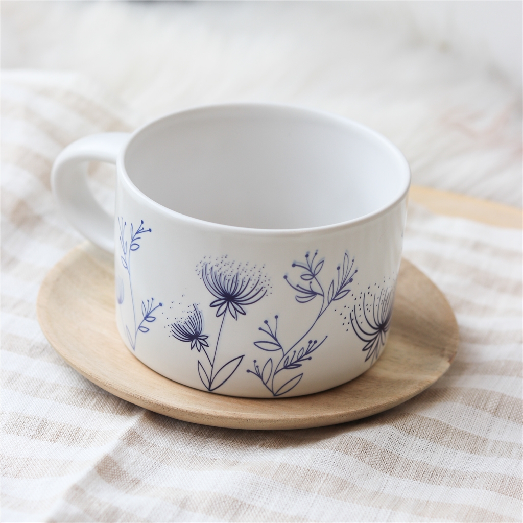 White mug with flower decoration