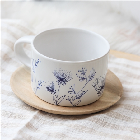 White mug with flower decoration