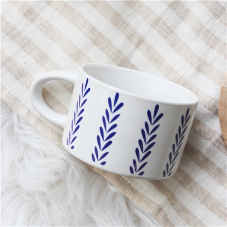 White mug with blue folklore decoration