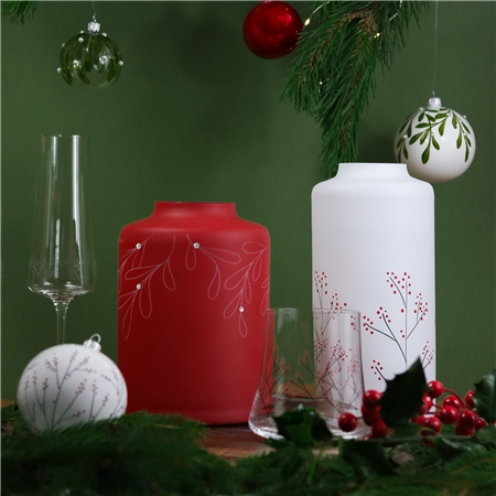 Red glass vase with mistletoe decor