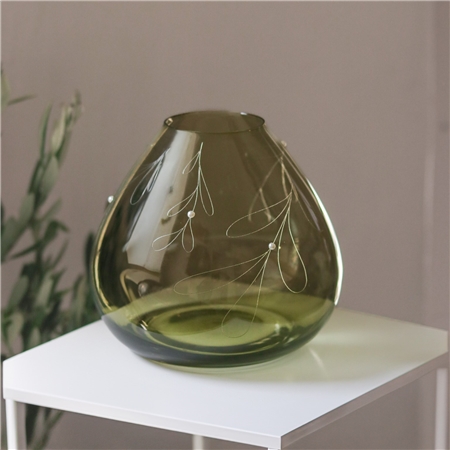 Green glass vase with mistletoe decor