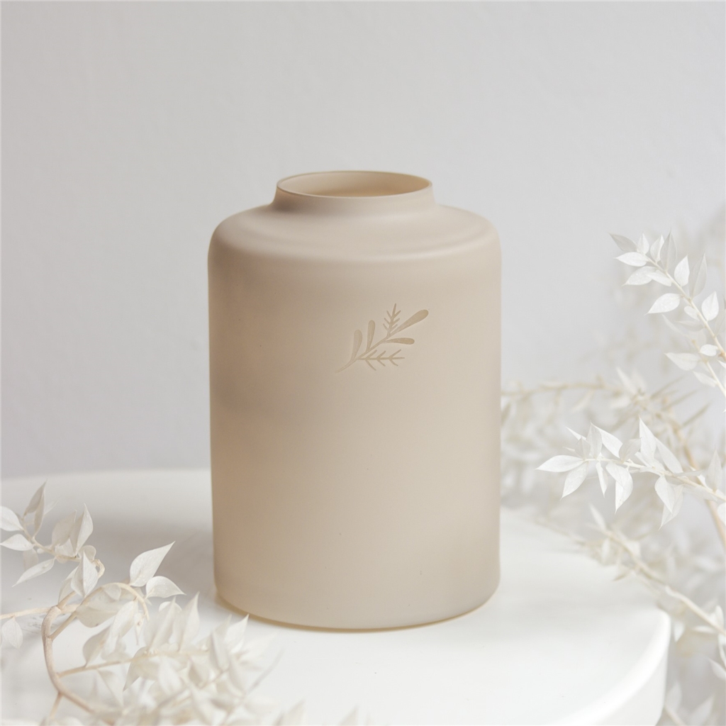 Low beige glass vase with twig decor