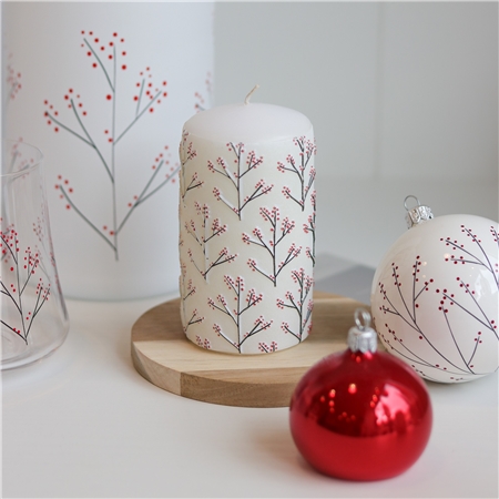 White candle with holly decor
