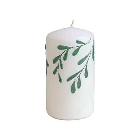 White candle with mistletoe decor