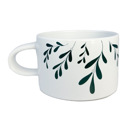 White mug with mistletoe decoration