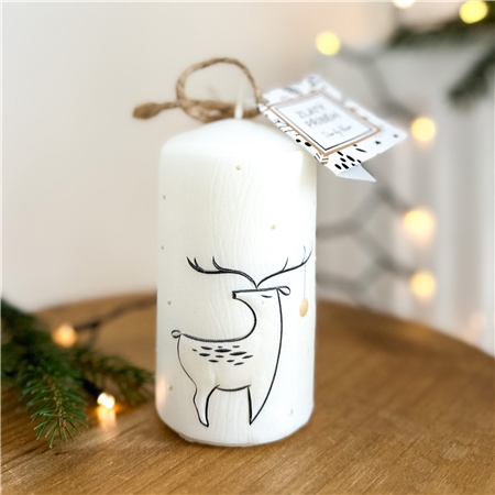 White candle with deer decor