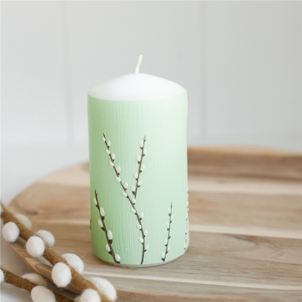 Pastel green candle with cat decoration