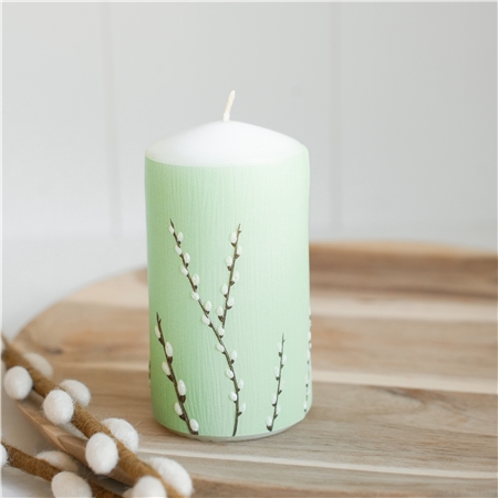 Pastel green candle with cat decoration