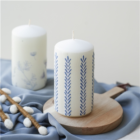 White candle with leaf decoration