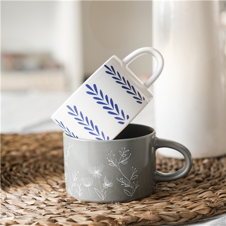 Grey mug with plant decoration