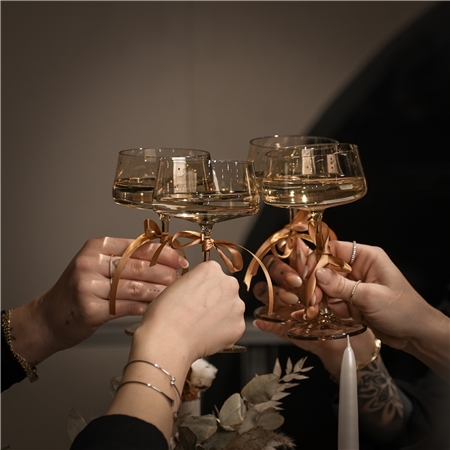 Set of gold cocktail glasses with polka dots