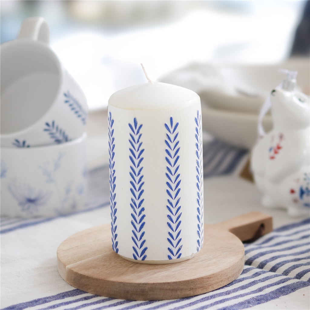 White candle with leaf decoration