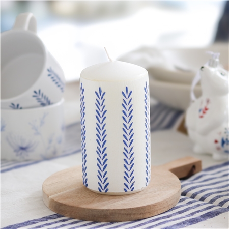 White candle with leaf decoration