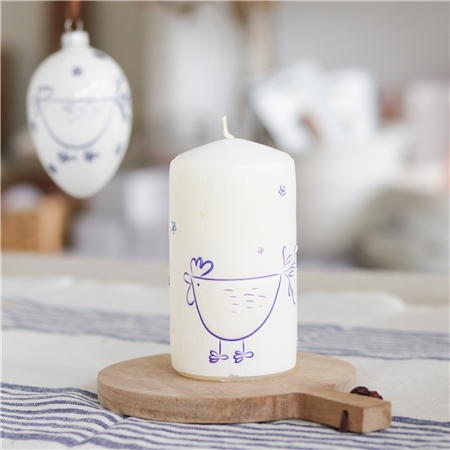 White candle with hen decoration