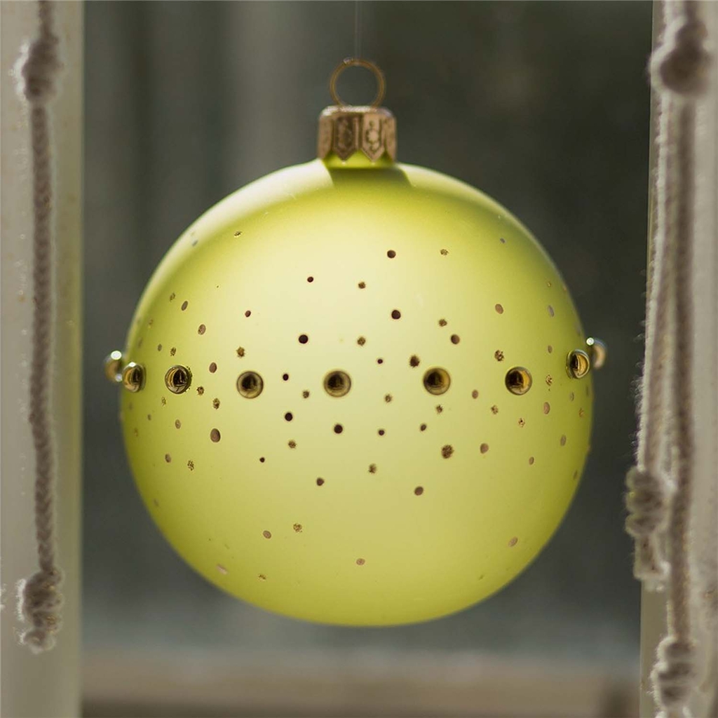 Glass ornament in matte green color with gold pearls and polka dots decor