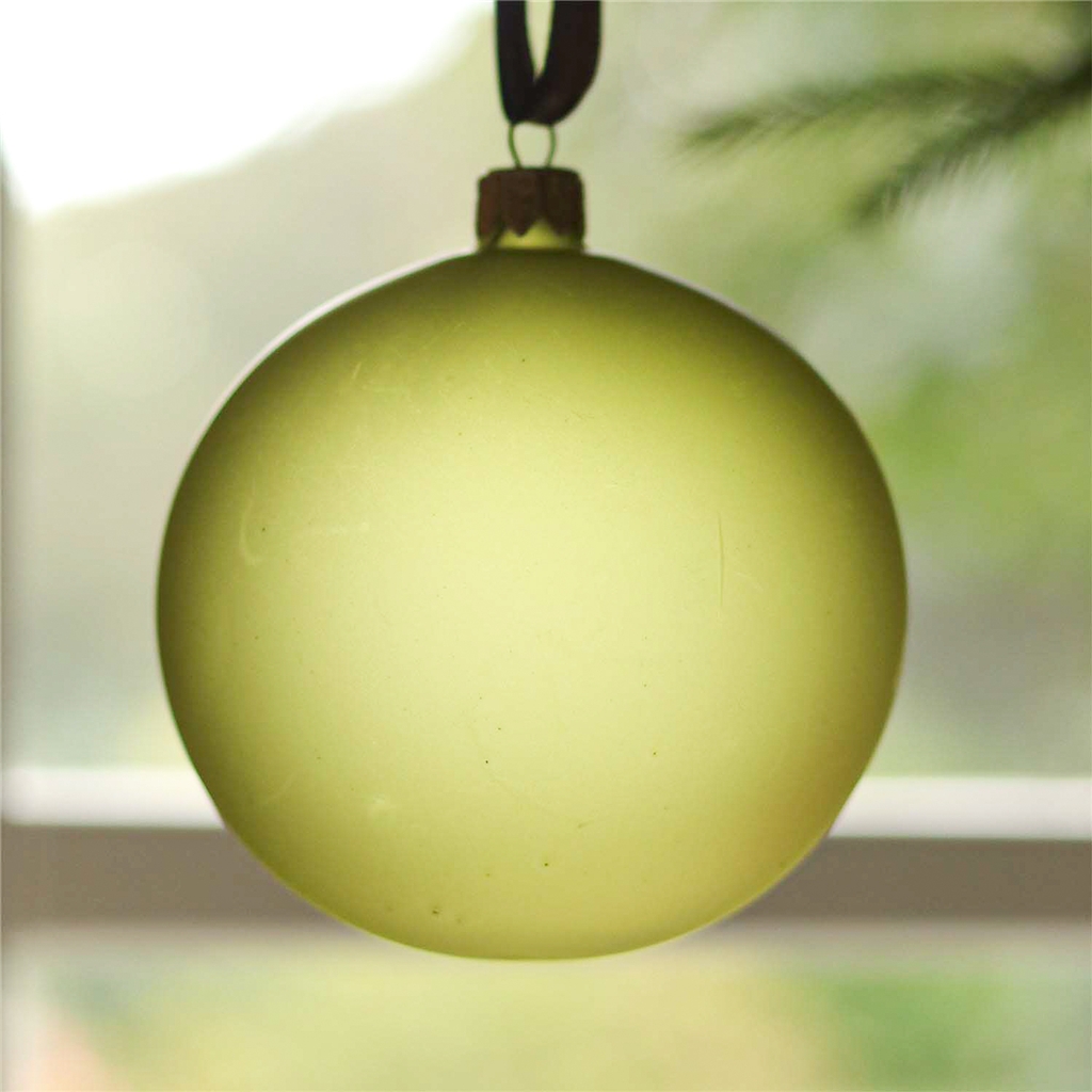 Glass ornament in matte green color