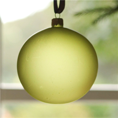 Glass ornament in matte green color