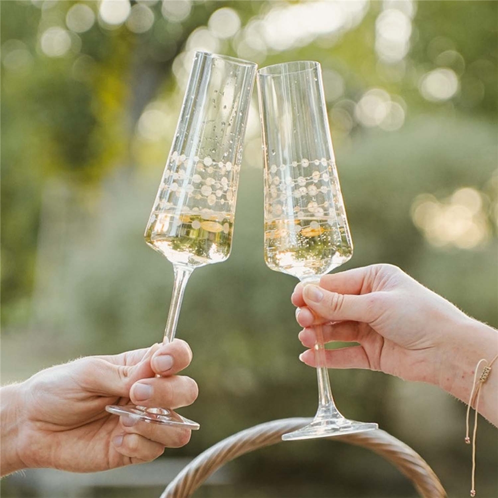 A set of champagne glasses with a gold chain