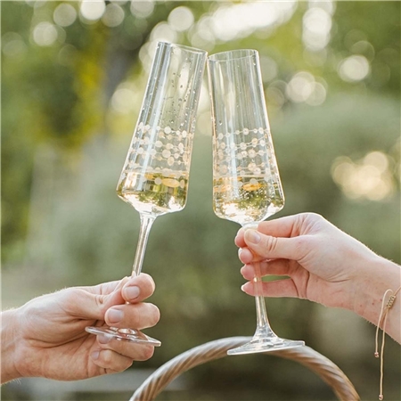 A set of champagne glasses with a gold chain
